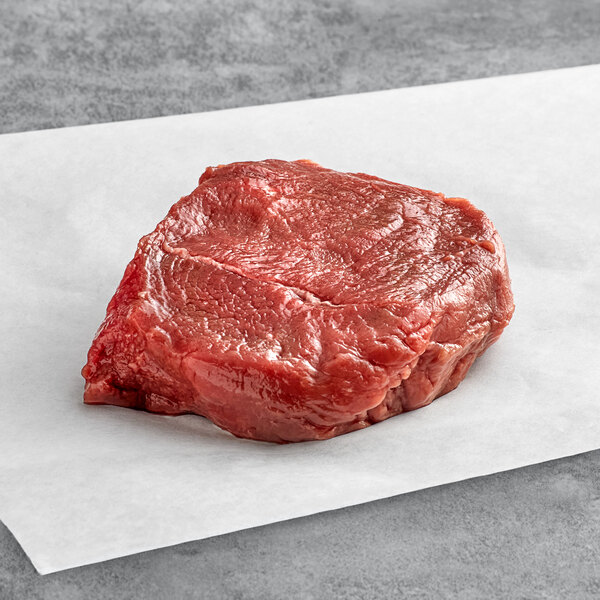 a piece of raw meat on a white paper