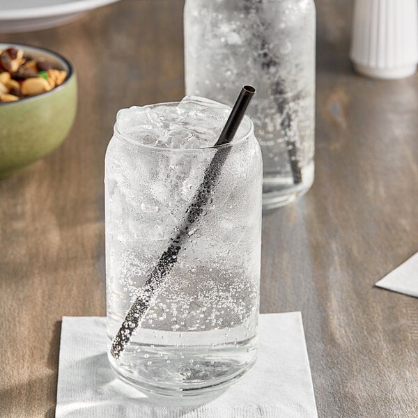 A glass of Jones Lemon Lime soda with a straw in it.