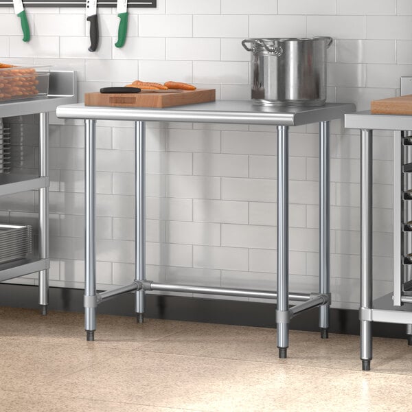 A Steelton stainless steel work table with a cutting board and a pot on it.