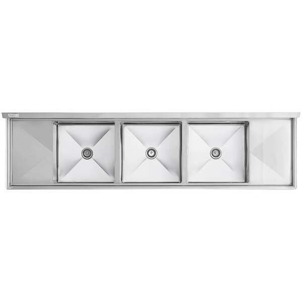 A Regency stainless steel sink with three bowls and two drainboards.