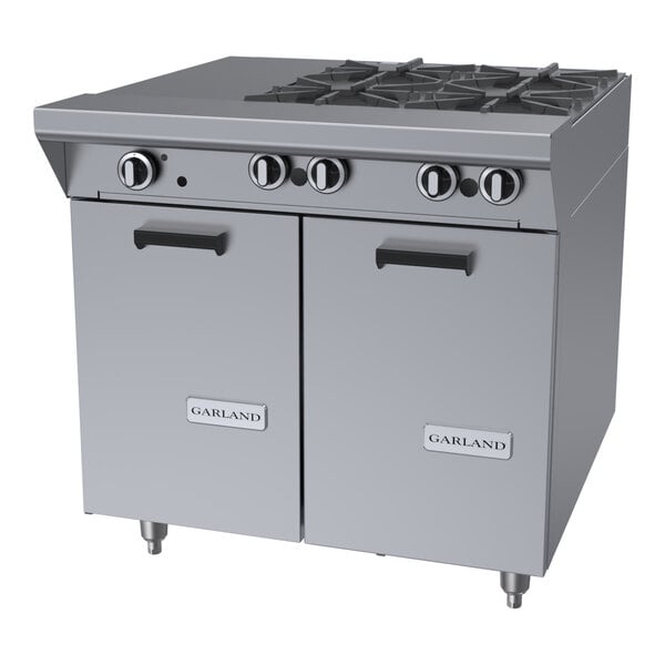 A commercial stainless steel 4-burner gas range with an even heat hot top and storage base.