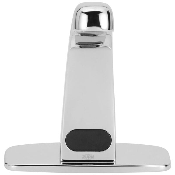 A silver Zurn deck mount sensor faucet with a black button.