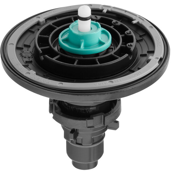 A close-up of a black and green circular diaphragm repair kit for a Sloan Optima Plus urinal.