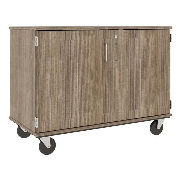 A dark brown wooden I.D. Systems storage cart with slotted doors and wheels.