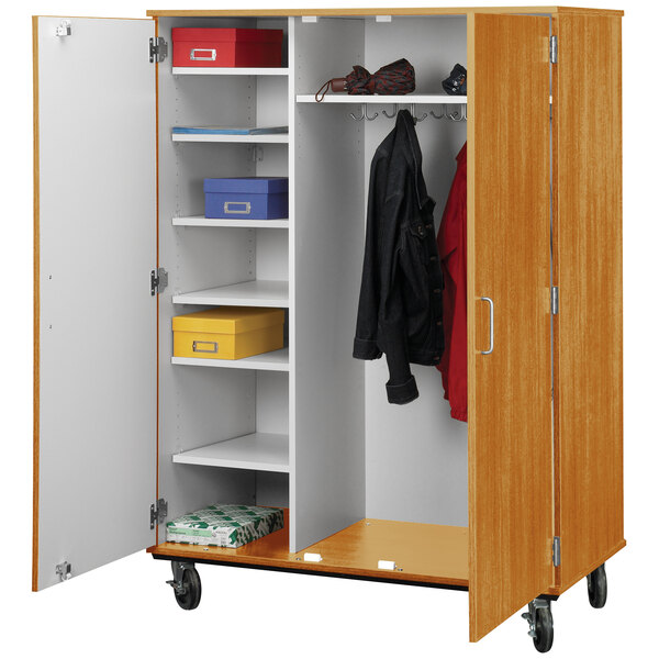 A light oak wooden cart with closed shelves and a white door.