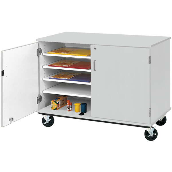 A grey I.D. Systems storage cart with shelves and a door open.