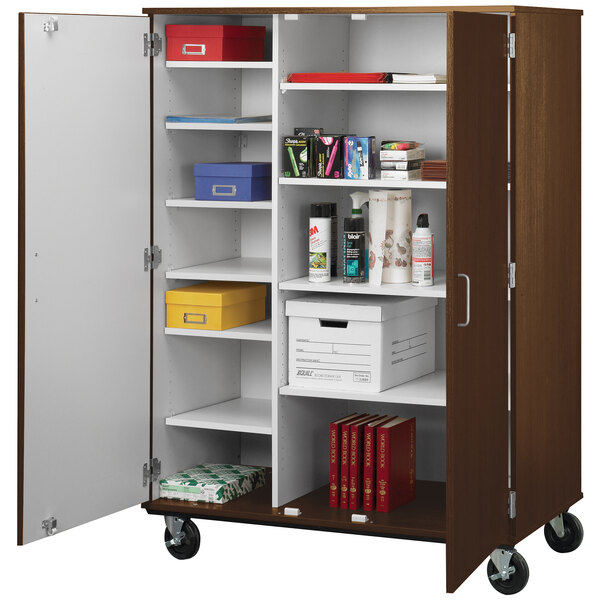 A dark walnut I.D. Systems storage cart with shelves holding books and files.