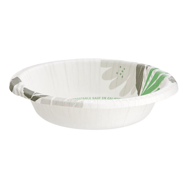 A white Dixie paper bowl with a green and white flower design.