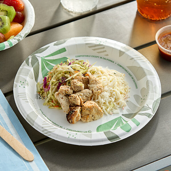 A Dixie Ultra Pathways paper plate with food and a drink on a table.