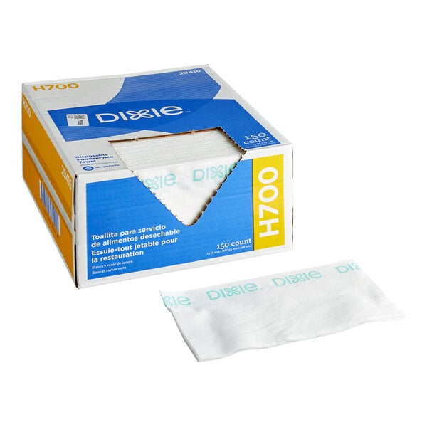 A box labeled 'Dixie H700' containing white disposable foodservice towels with green text, with one towel displayed in front of the box.