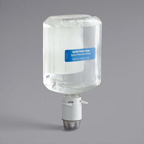 A Pacific Blue Ultra manual hand soap dispenser with a clear container on a gray surface.