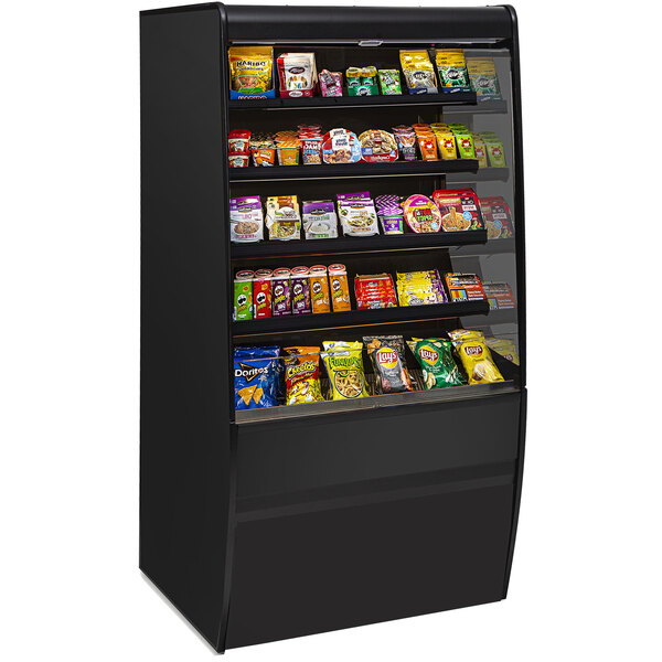 A black Federal Industries Vision Series non-refrigerated display case with shelves of food on it.