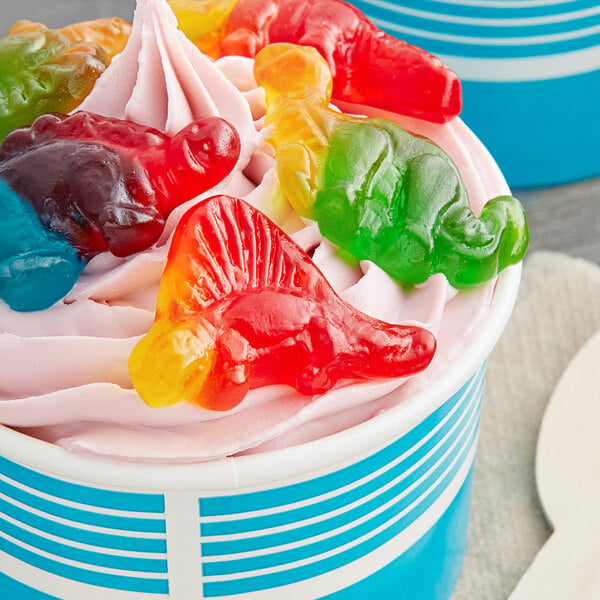 A cup of ice cream with Vidal Gummy Dinosaurs on top.