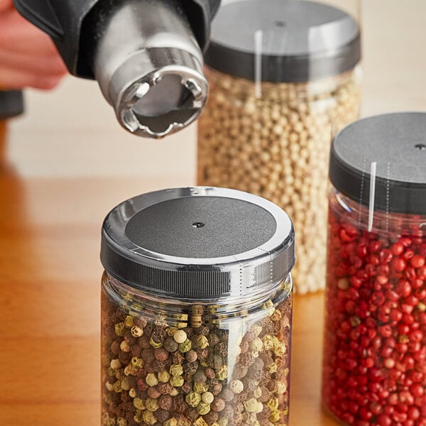 A clear shrink band on a jar of peppercorns.