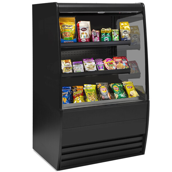 A black non-refrigerated display case with different types of food on shelves.