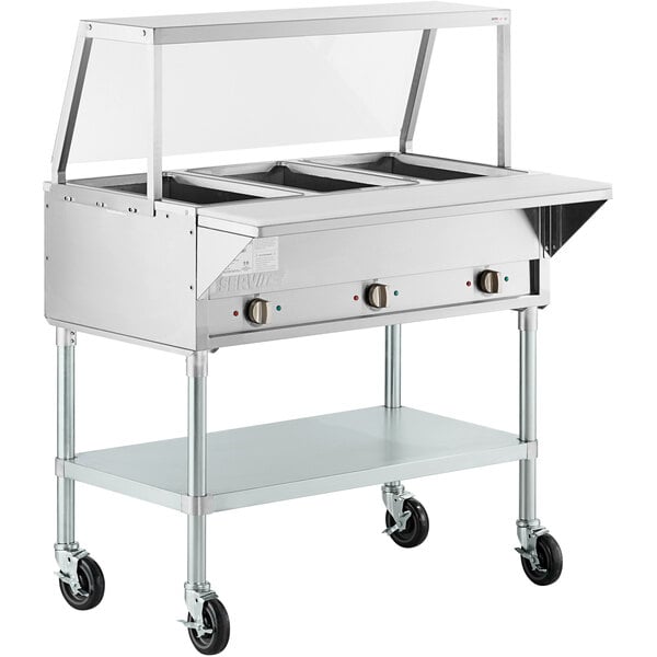 A ServIt stainless steel open well electric steam table on wheels.