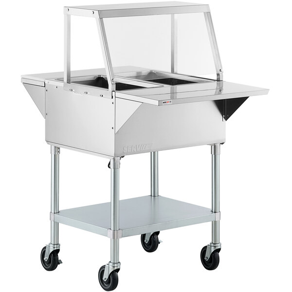 A ServIt stainless steel electric steam table with an angled sneeze guard over two open wells.