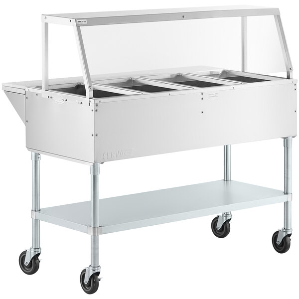 A ServIt stainless steel electric steam table on casters with an angled glass sneeze guard.