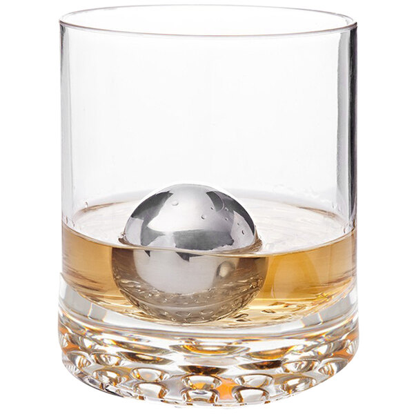 A glass with a Franmara stainless steel ice sphere inside it.