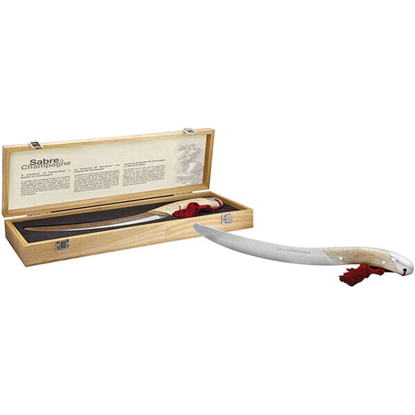A Pulltex champagne saber with wood handle in a wooden box.