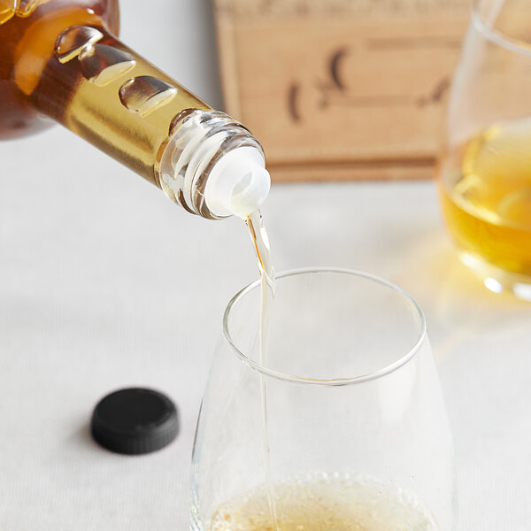 A bottle of Franmara Slo-Vino pouring liquid into a glass.