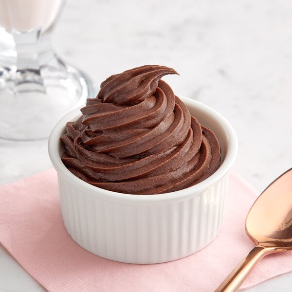 A bowl of Creamery Ave. chocolate soft serve ice cream with a spoon.