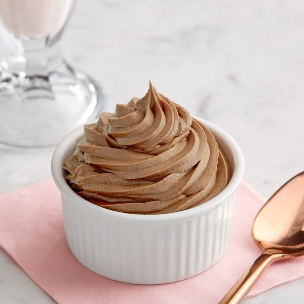 A bowl of brown Creamery Ave. Espresso soft serve with a spoon.