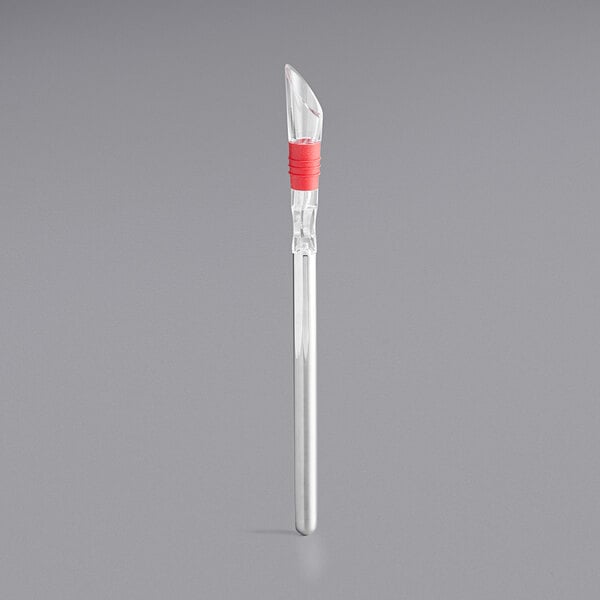 A clear acrylic tube with a red rubber top and silver tool.