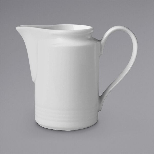 A RAK Porcelain ivory porcelain creamer with an embossed design and handle.