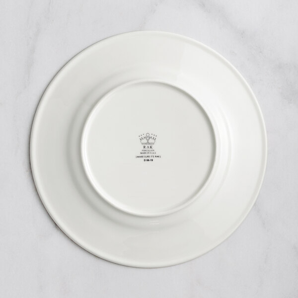 A RAK Porcelain ivory porcelain plate with an embossed logo.