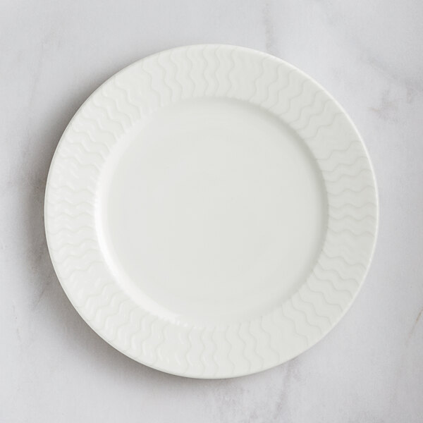 A RAK Porcelain ivory porcelain plate with a wavy pattern.