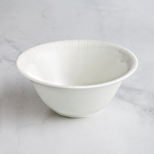 A RAK Porcelain Leon ivory porcelain bowl with wavy lines on the rim.