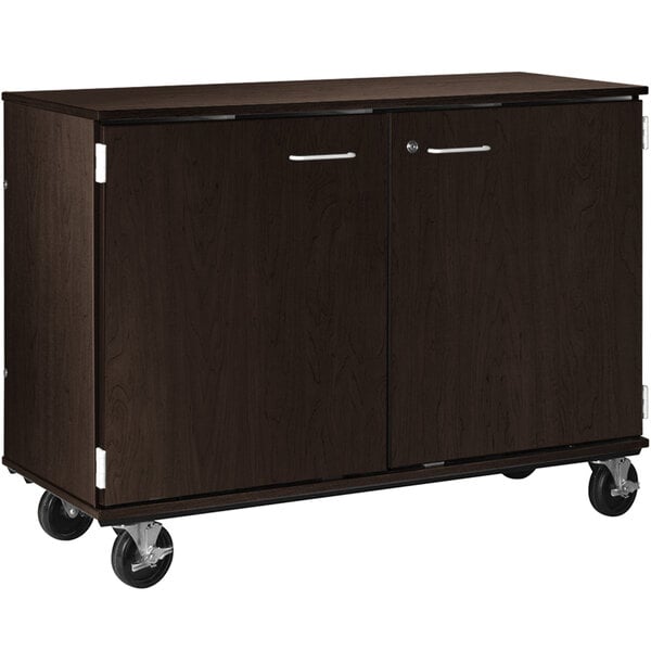 A brown I.D. Systems cabinet with wheels.