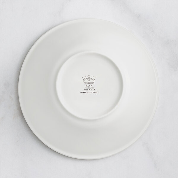 A stackable ivory porcelain bowl with an embossed crown on it.