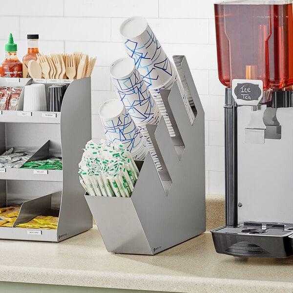 A ServSense stainless steel countertop organizer with sections for cups, lids, and straws.