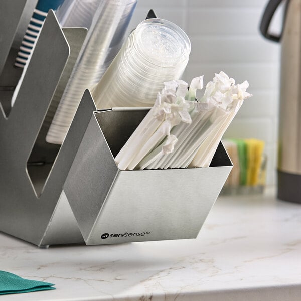 A stainless steel straw caddy attachment holding wrapped straws, designed for self-service station organizers.