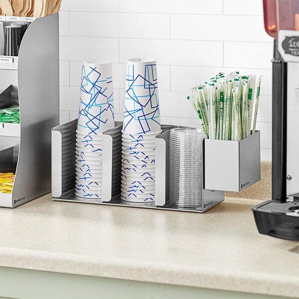 A ServSense stainless steel countertop cup and lid holder with straw caddy attachment holding cups and straws.