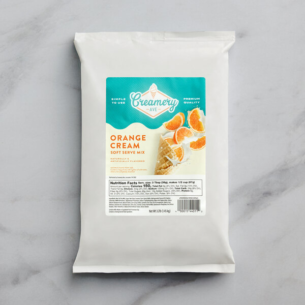 A bag of Creamery Ave. Orange Cream soft serve mix on a white surface.