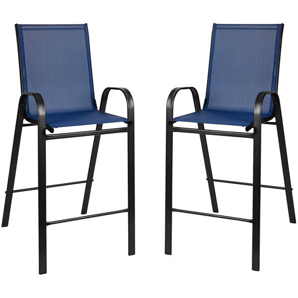 A Flash Furniture outdoor bar table with a navy glass top and two navy chairs with black frames.