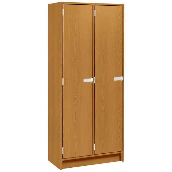 A light oak I.D. Systems wooden locker cabinet with two doors.