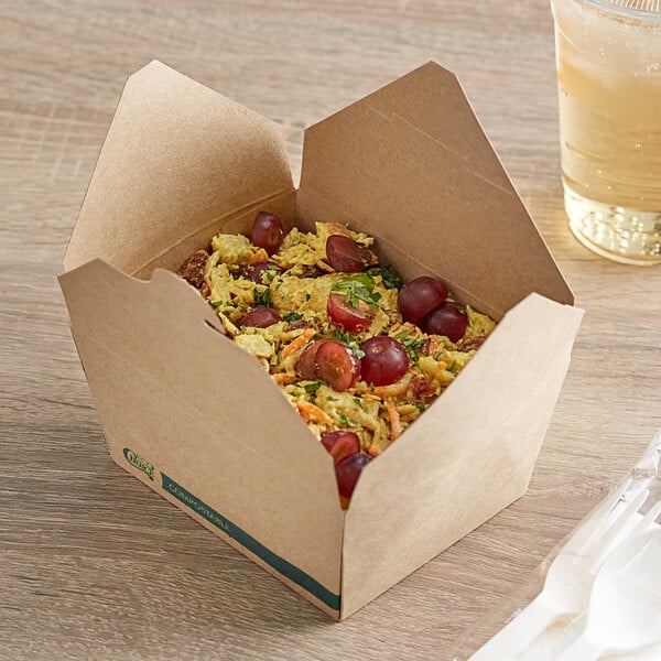 A EcoChoice Kraft paper take-out box filled with rice and vegetables on a table.