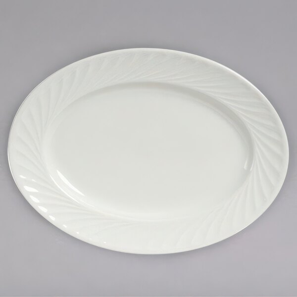 A white oval Tuxton china platter with a swirl rim design.