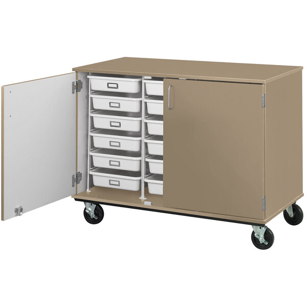 A tan I.D. Systems mobile storage cabinet with open door and drawers on wheels.