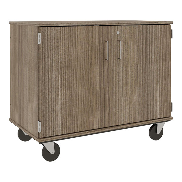 A dark brown I.D. Systems mobile storage cabinet with black wheels.