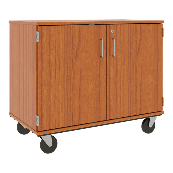 A medium cherry wooden cabinet on black wheels with 18 bins inside.