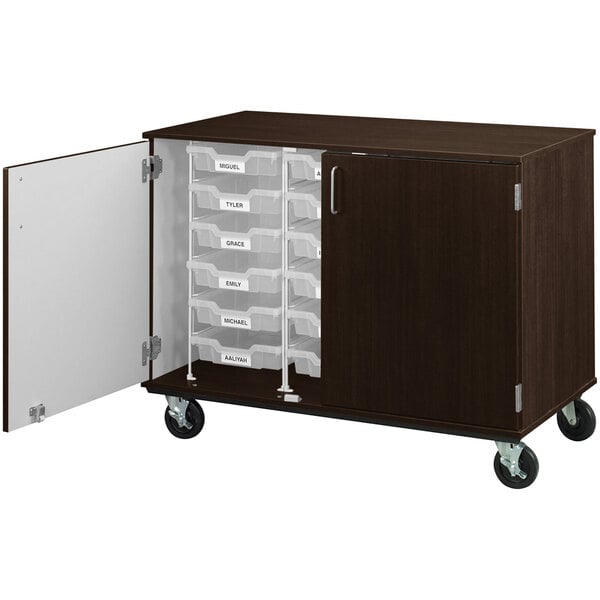 A brown cabinet with white drawers on wheels.