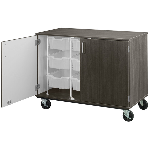 A dark elm I.D. Systems mobile storage cabinet with (9) 6" bins and a door open.