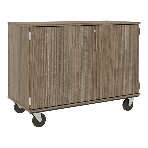 A brown I.D. Systems mobile storage cabinet with black wheels and silver handles.