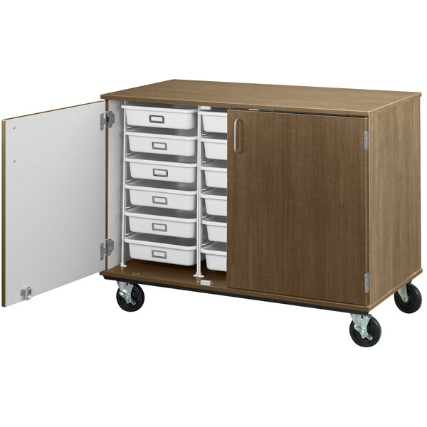 A Roman walnut I.D. Systems mobile storage cabinet with open door and drawers on wheels.