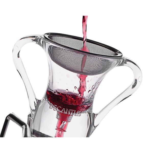 A Decantus stainless steel sediment screen being used to pour red wine into a glass container.